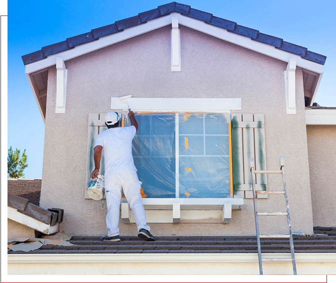 A man painting the outside of a house.